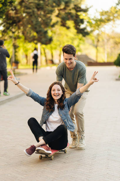 istock Young Couple practicing skateboarding outdoors 1338241627
