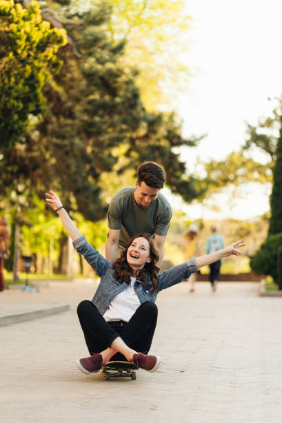 istock Young Couple practicing skateboarding outdoors 1338241633