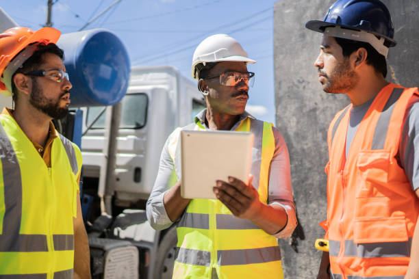istock Coworkers doing a meeting in a construction site 1338243643