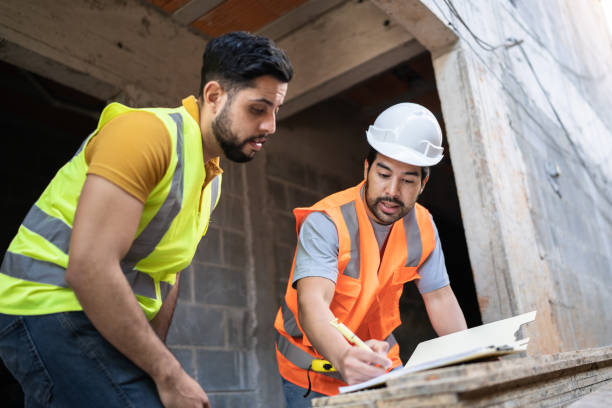 istock Coworkers doing a meeting in a construction site 1338244298