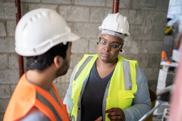 istock Coworkers doing a meeting in a construction site 1338244870