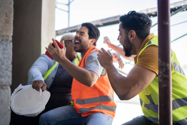 istock Construction workers watching sports match on smartphone in a construction site 1338244871