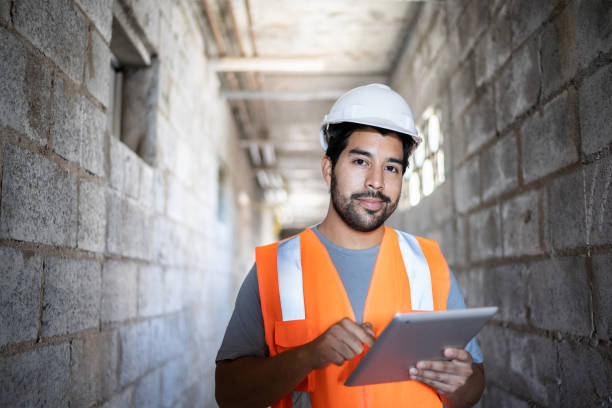 istock Portrait of an engineer using digital tablet in a construction site 1338244903
