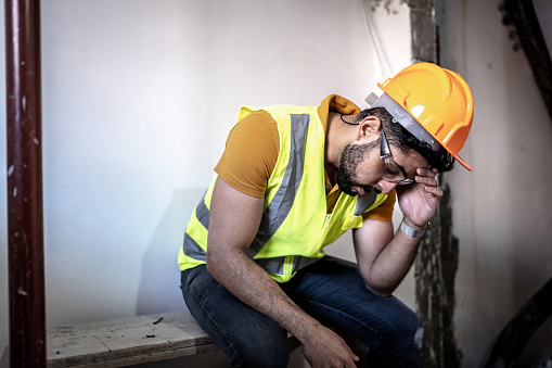 Exhausted construction worker at construction site
