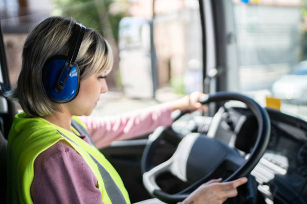 istock Female trucker driver inside the truck at a construction site 1338247342