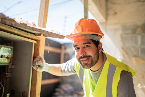 istock Portrait of an electrician at a construction site 1338247355