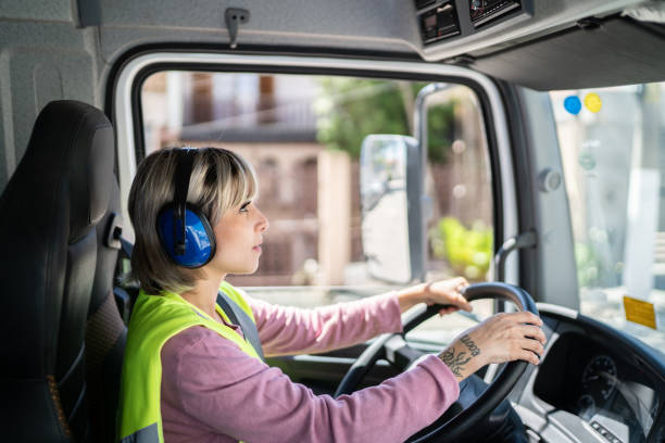 istock Female trucker driver inside the truck at a construction site 1338247427