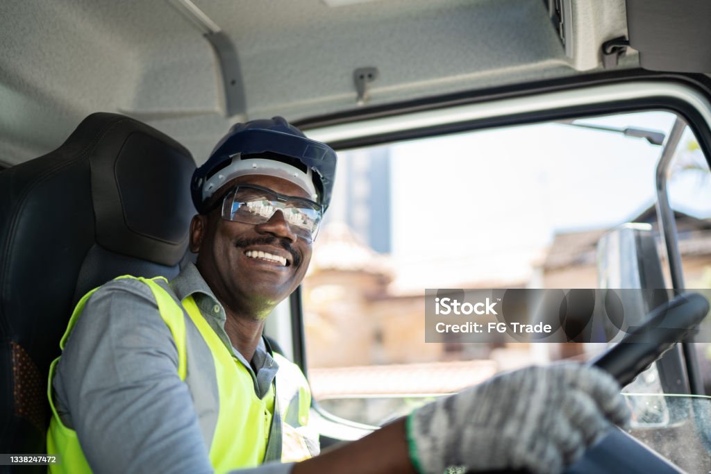 Portrait of a truck driver inside the truck at a construction site Truck Driver Stock Photo