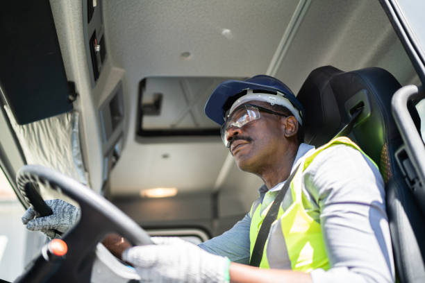istock Truck driver inside the truck at a construction site 1338247482