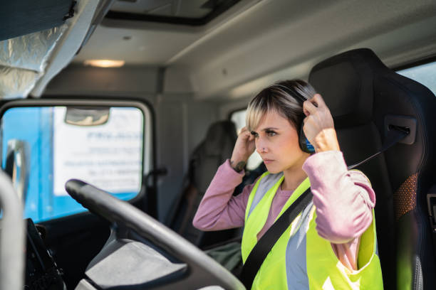 istock Female trucker driver inside the truck at a construction site 1338247484