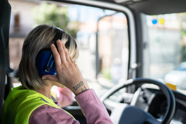 istock Female trucker driver inside the truck at a construction site 1338247520