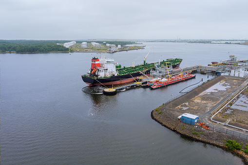 Aerial view of oil tanker ship moored at a oil storage terminal in port