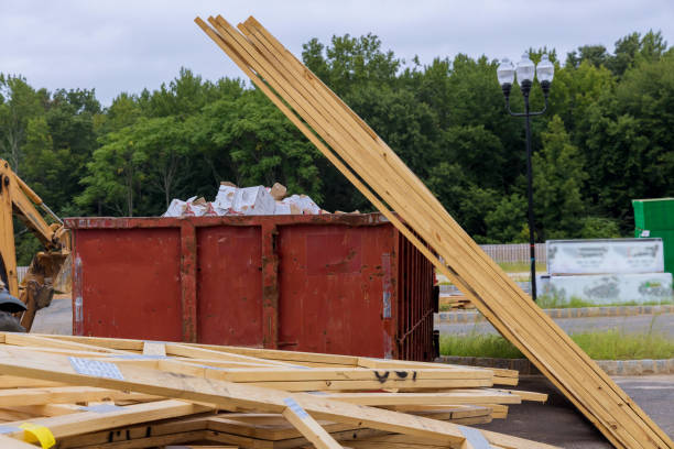 istock Construction trash dumpsters in an metal container, stacker wooden material boards and beams home house renovation. 1338254659