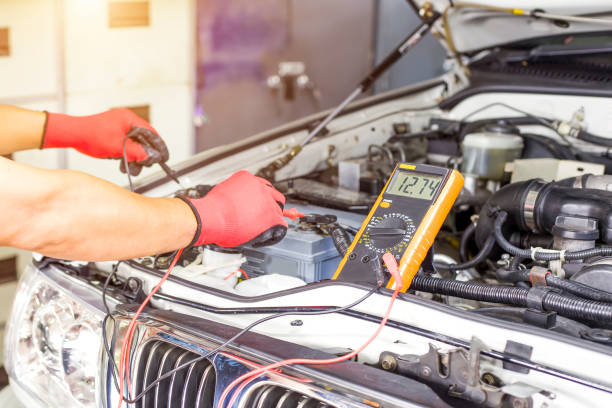 istock A technician is checking the car battery for availability. 1338254951