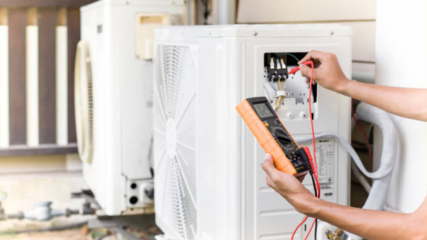 istock Air conditioner repairman using electricity meter to check air conditioner operation, maintenance concept 1338254996