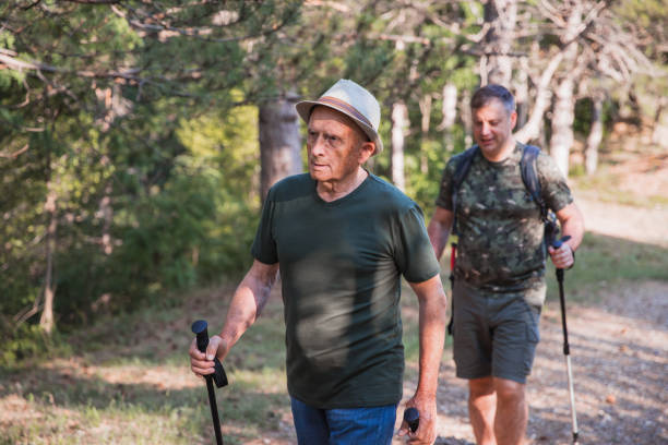 senior man on a hike with his son - explorer tourist frowning men imagens e fotografias de stock