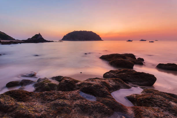 istock Beautiful sunset on the rock beach. 1338256997