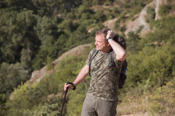 istock Hiker looking for a direction on a hot summer day 1338258739