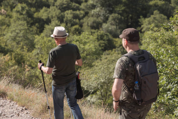 istock Senior man leading his mid age son onto a hike 1338258786