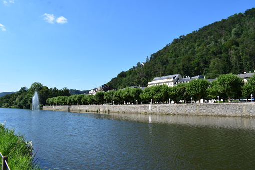 view down the  river Lahn in Bad Ems with the Kurpark and white buildings behind