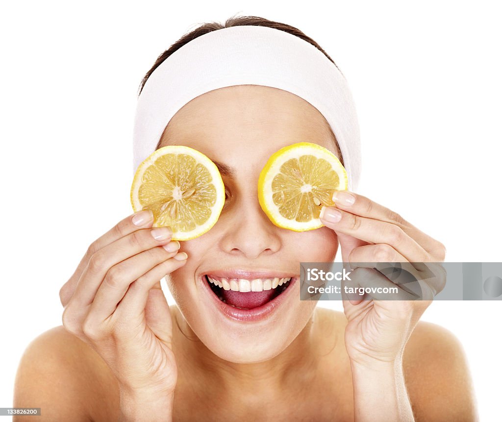 A smiling woman having a fruit facial Natural homemade fruit  facial masks . Isolated. Adult Stock Photo