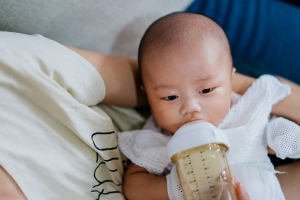 istock Asian baby drinking milk with a baby bottle 1338263035