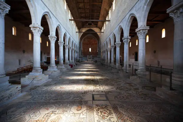 Basilica di Santa Maria Assunta (the current building dating to the eleventh century, rebuilt in the thirteenth century) is the main church of Aquileia, an ancient Roman city.  - Here the inside full of mosaics everywhere Friuli Venezia Giulia, Italy