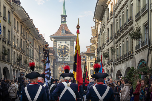 Bern, Switzerland - Nov 25, 2019: Zytglogge and a Parade of swiss soldiers on traditional costume during Zibelemarit Holiday (Onion Market) - Bern, Switzerland