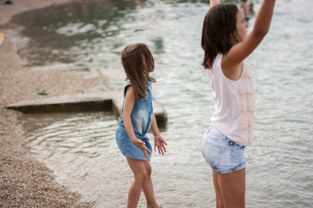 istock Girls having fun at the beach 1338264053