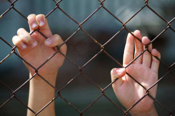 istock prisoner's hand arrest in jail 1338264465