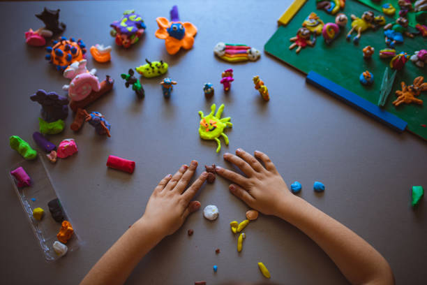 istock Creative girl making homework from the artistically educational subject with plasticine 1338265929