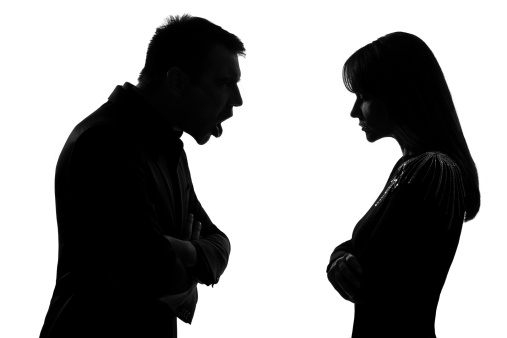 one caucasian couple man and woman face to face screaming shouting dipute in studio silhouette   on white background