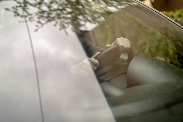 istock Man driving his car with a protection mask 1338274263