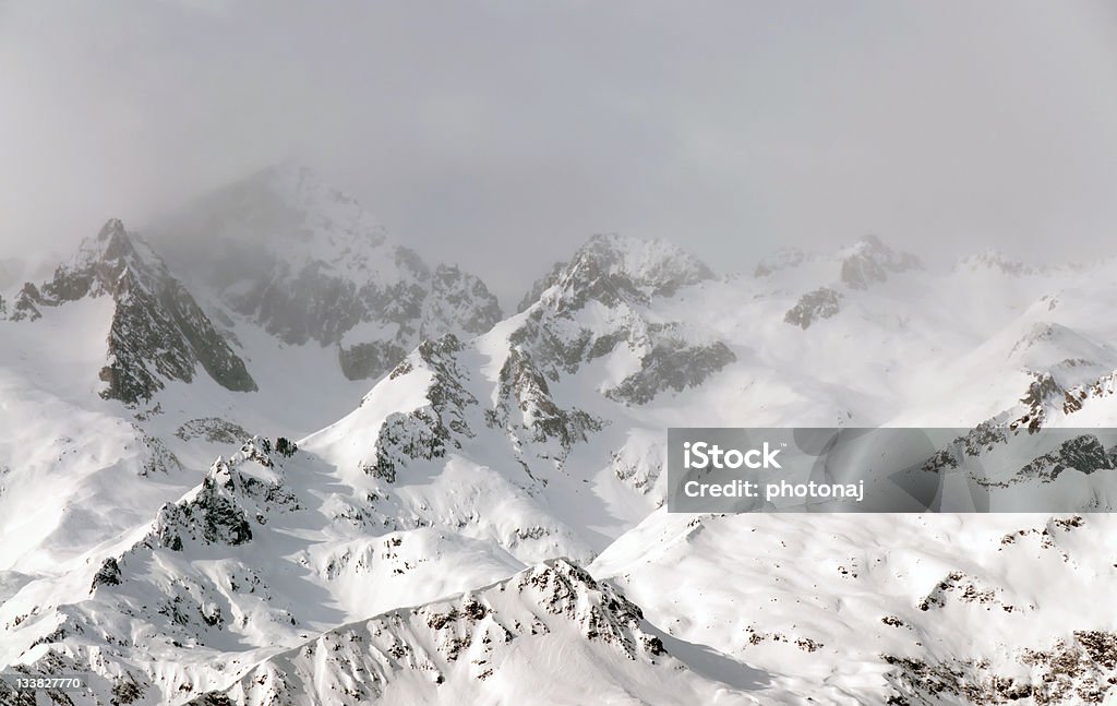 Foggy mountains in winter, Italy Snowy mountains of the Dolomites in fog, Italy, Europe Cloud - Sky Stock Photo