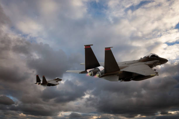 istock Jet fighters flying over the clouds. 1338279447