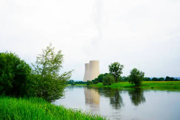 Nuclear power plant in Grohnde with cooling towers and surrounding landscape.