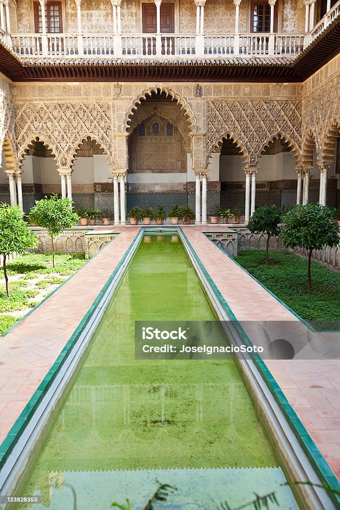 Courtyard of the Maidens. Real Alcazares. Seville. The name, meaning "The Courtyard of the Maidens", refers to the legend that the Moors demanded 100 virgins every year as tribute from Christian kingdoms in Iberia. The story of the tribute was used as a myth to bolster the Reconquista movement. UNESCO World Heritage Site. http://en.wikipedia.org/wiki/Alc%C3%A1zar_of_Seville Ancient Stock Photo