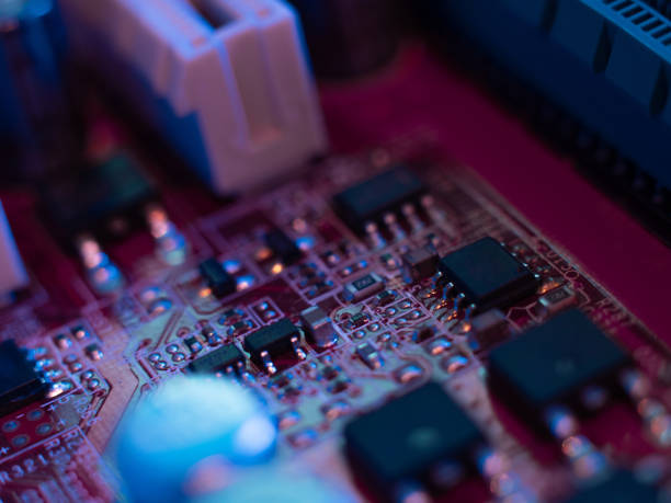 istock Computer motherboard, microchips close-up in color illumination, 1338284285