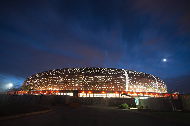Soccer City,johannesburg Johannesburg, South africa - march, 20th 2010: nigh shot of soccer city in soweto-johannesburg, The stadium capable of 80000 people hosted the first and final match of the world cup 2010 soweto stock pictures, royalty-free photos & images