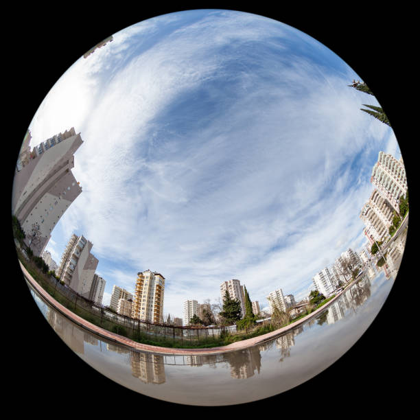 General view of Antalya city in daytime. Medium group of concrete buildings and skyscrapers are seen in view. Shot from a low angle viewpoint. No people are seen in frame. Shot with a full frame DSLR camera and a fish eye lens so the photo is seen spheric round.