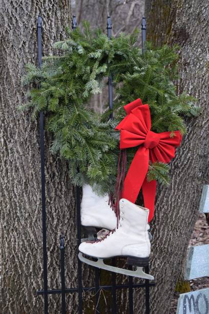 istock Ice skates and wreath on tree 1 1338297918