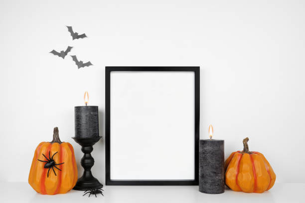 istock Halloween mock up black frame on a white shelf with pumpkin decor and black candles 1338298953