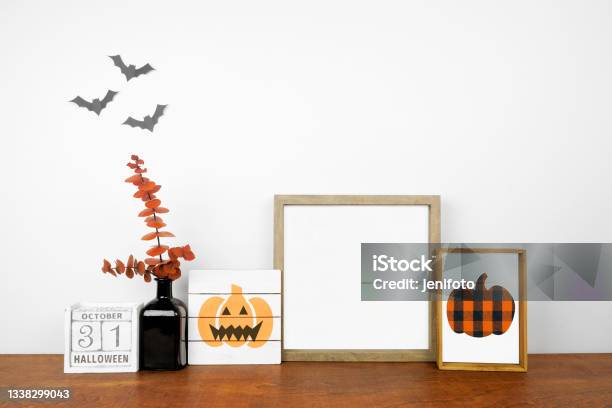 Halloween Mock Up Frame And Shabby Chic Decor On A Wood Shelf Against A White Wall Stock Photo - Download Image Now