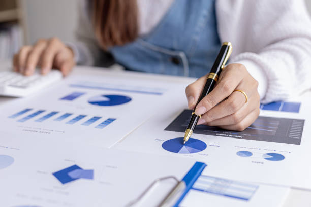 istock A financial scholar is pointing at a document with a pen, she is analyzing and checking company financial data for accuracy before presenting it to the meeting. Financial audit concept. 1338300126