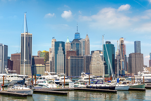 Luxury boat against Manhattan cityscape background in New York City, NY, USA