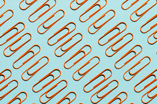 Flat lay of Paperclips on blue background