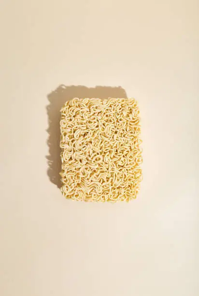 Instant noodles on a beige background. Top View