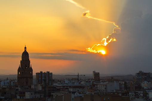 Spectacular sunset over the city of Murcia with the cathedral tower in the foreground