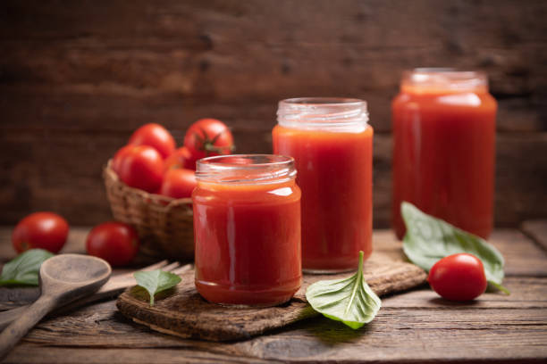 istock Tomato sauce in a glass jar on a rustic wooden table 1338309634