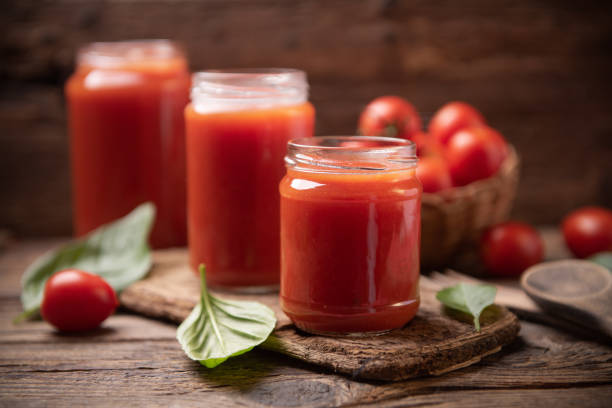 istock Tomato sauce in a glass jar on a rustic wooden table 1338309653